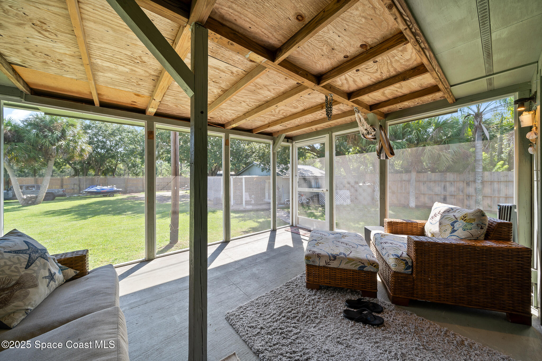 9633 Honeysuckle Drive Sebastian, FL 32976 - Photo 30 of 40 a balcony with furniture and a garden