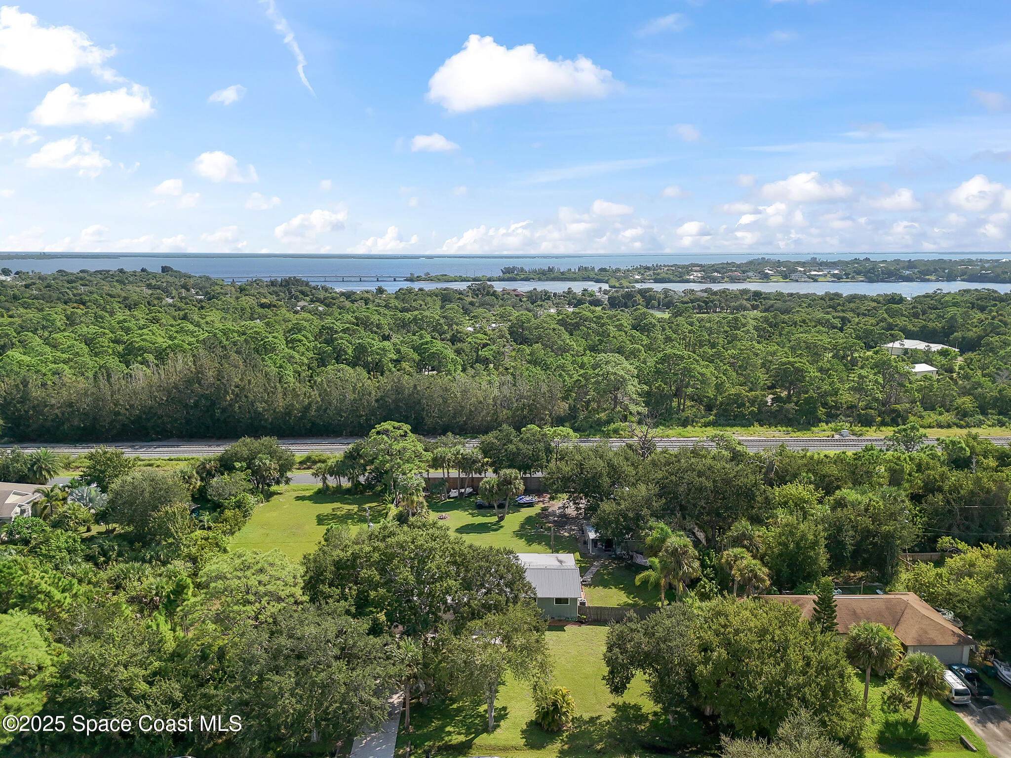 9633 Honeysuckle Drive Sebastian, FL 32976 - Photo 32 of 40 a view of a lake with a city