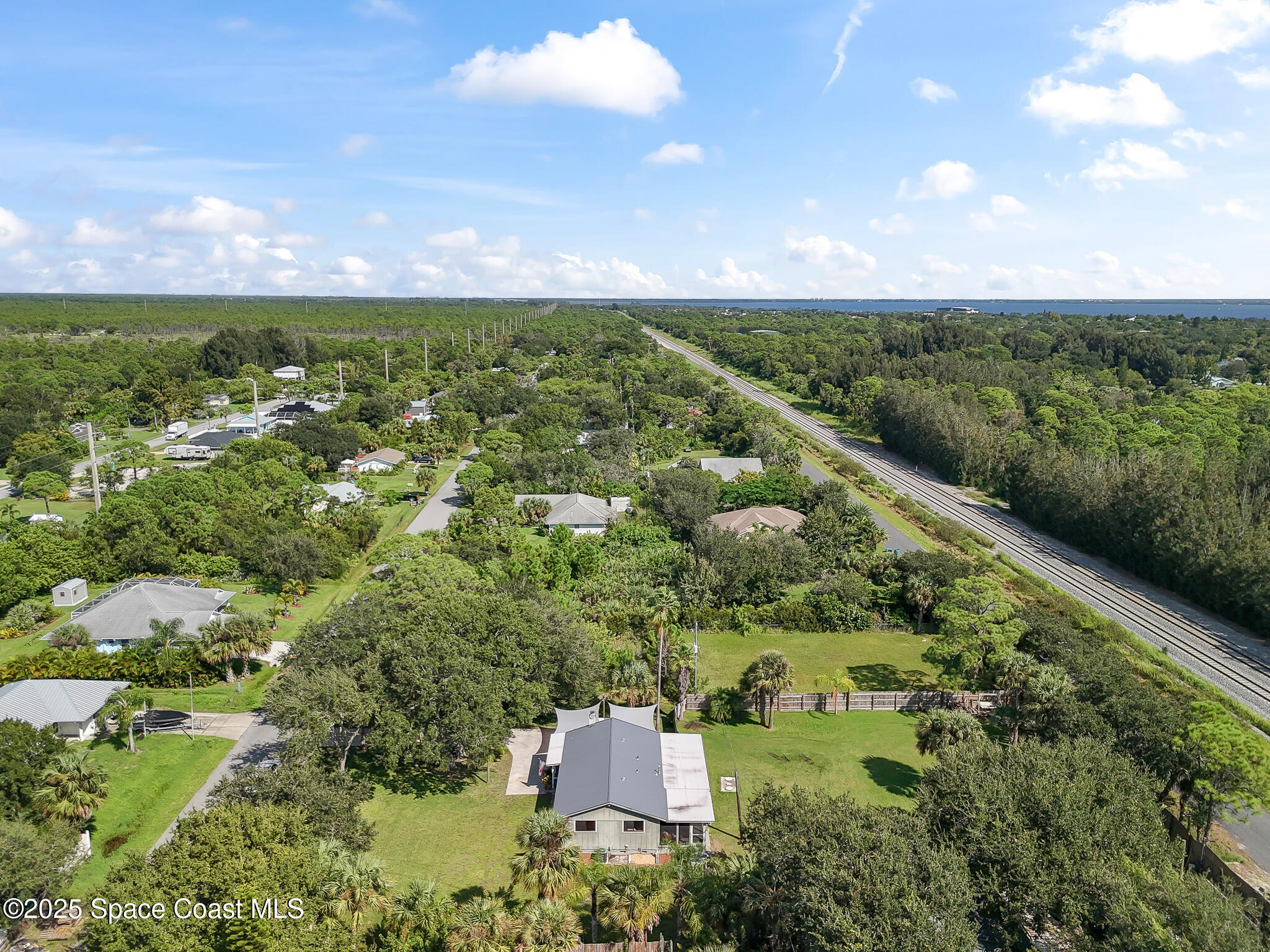 9633 Honeysuckle Drive Sebastian, FL 32976 - Photo 34 of 40 an aerial view of a houses with outdoor space and trees all around
