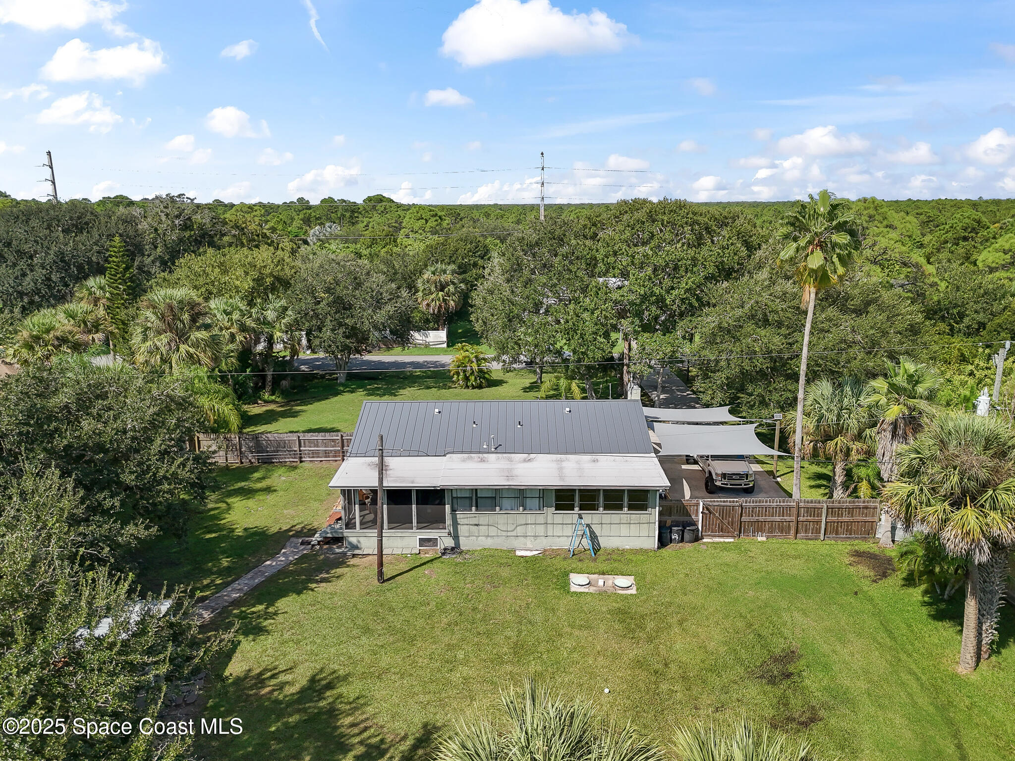 9633 Honeysuckle Drive Sebastian, FL 32976 - Photo 40 of 40 a view of a house with a backyard and a garden