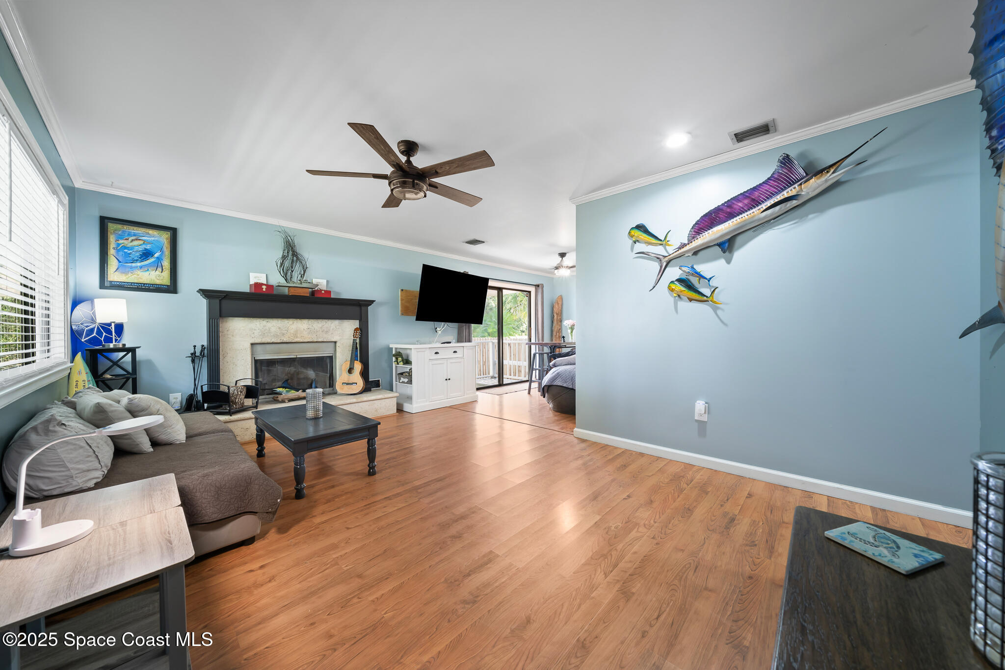 9633 Honeysuckle Drive Sebastian, FL 32976 - Photo 7 of 40 a living room with furniture and a fireplace
