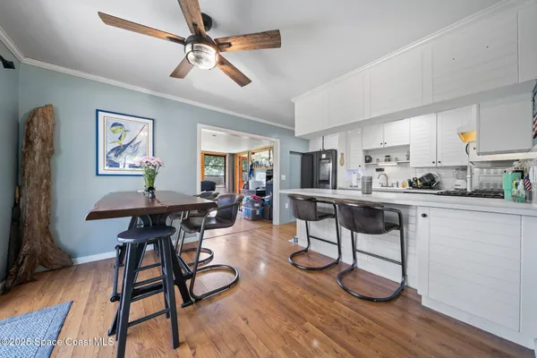 a kitchen with refrigerator cabinets and wooden floor