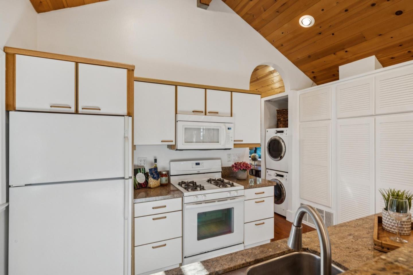 20080 Gist Road Los Gatos, CA 95033 - Photo 11 of 35 a kitchen with stainless steel appliances granite countertop a stove a refrigerator and a sink with white cabinets