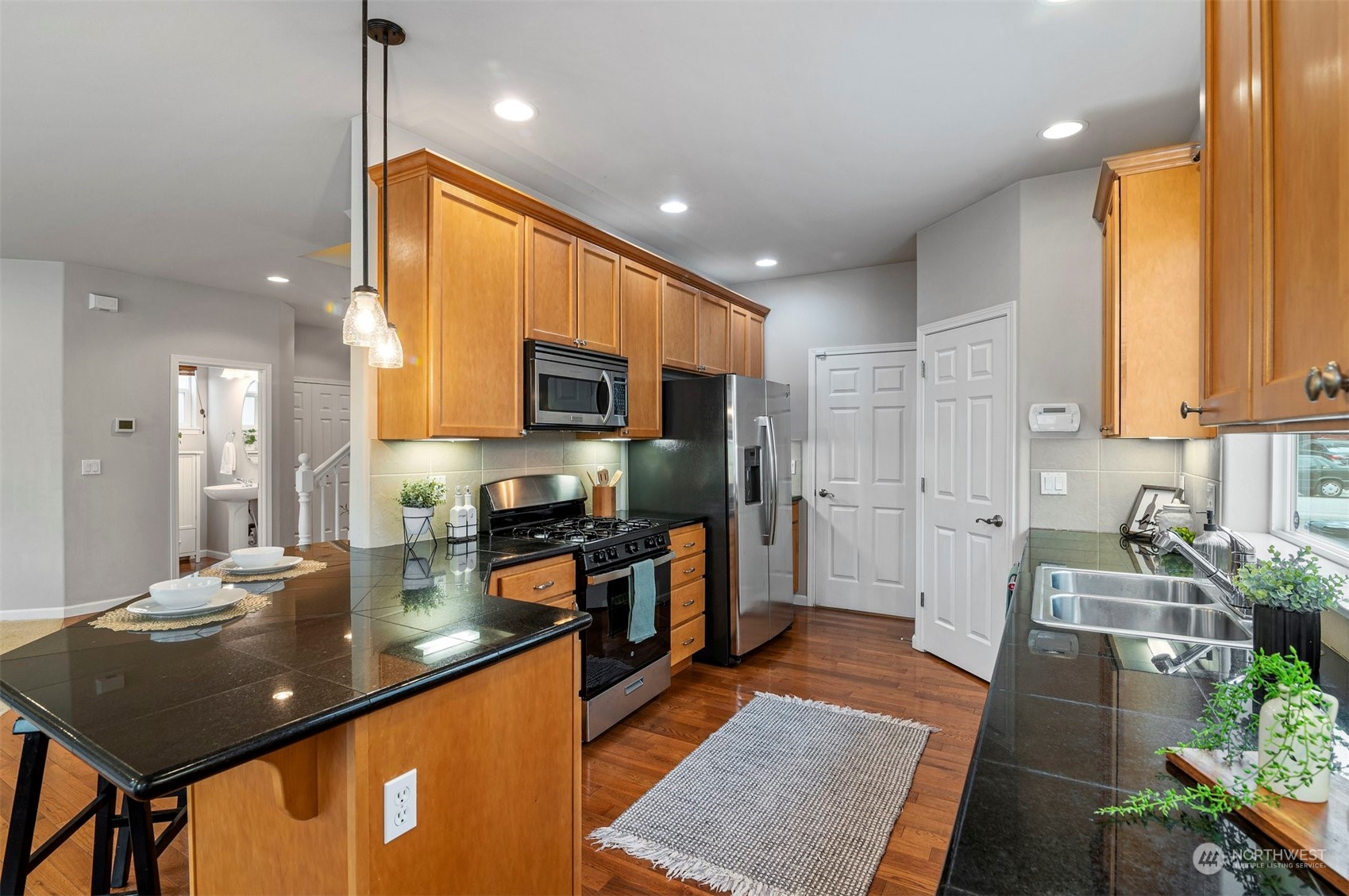 23617 17th Avenue West Bothell, WA 98021 - Photo 11 of 31 a kitchen with stainless steel appliances granite countertop sink stove refrigerator and cabinets