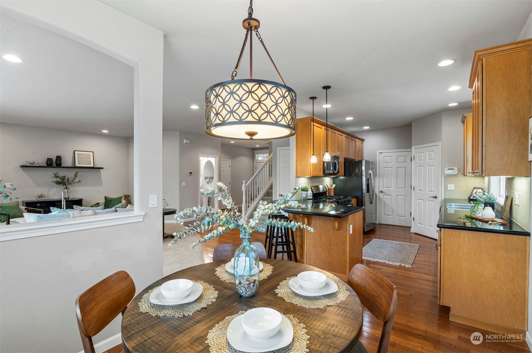 23617 17th Avenue West Bothell, WA 98021 - Photo 13 of 31 a view of a dining room with furniture a kitchen and chandelier