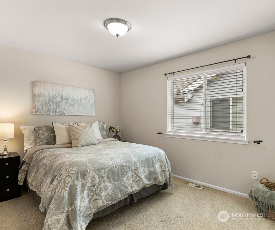23617 17th Avenue West Bothell, WA 98021 - Photo 22 of 31 a large bed sitting in a bedroom next to a window