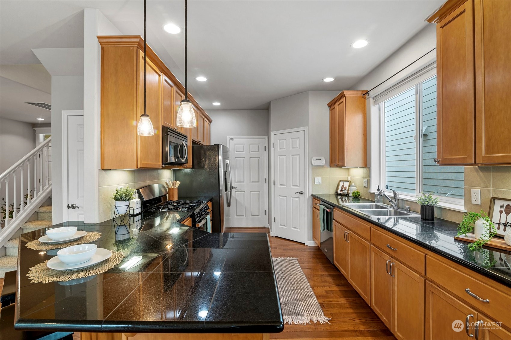 23617 17th Avenue West Bothell, WA 98021 - Photo 9 of 31 a large kitchen with stainless steel appliances lots of counter space and a sink