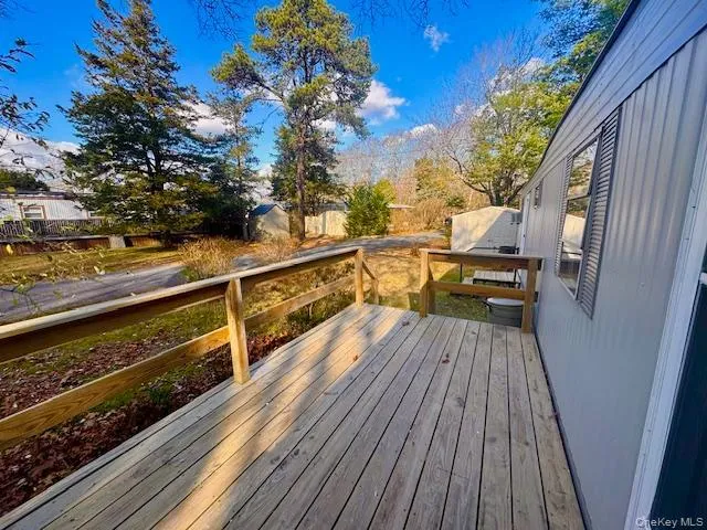 a view of balcony with wooden floor and outdoor seating
