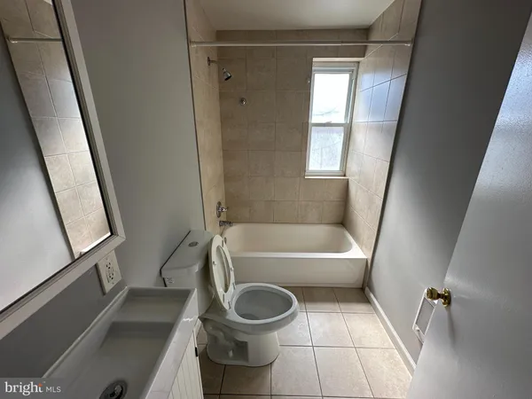 a bathroom with a toilet a sink and a bathtub