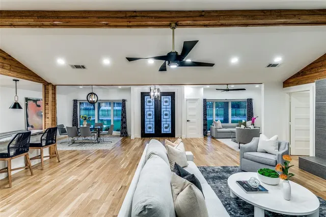 a living room with furniture a rug and a large window