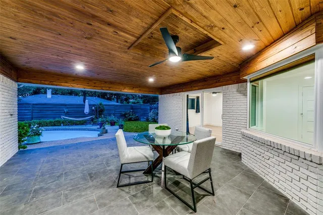 a view of a porch with furniture and a yard