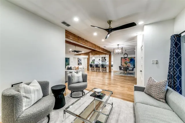 a living room with furniture and a view of dining room