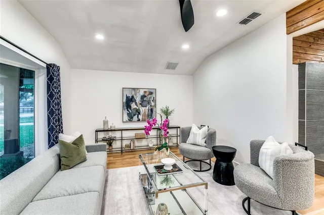 a living room with furniture and flowers
