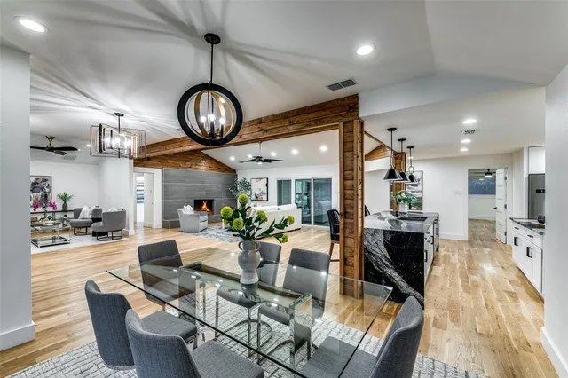 a view of a dining room with furniture a chandelier and wooden floor