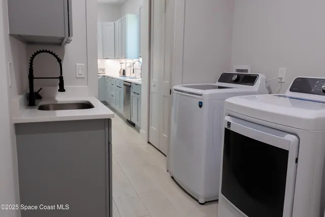 a kitchen with a sink and a stove with wooden floor