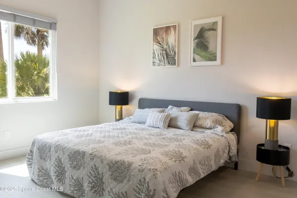 a bedroom with a bed and glass window