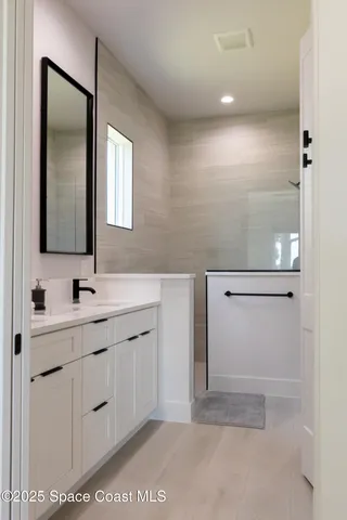 a bathroom with a double vanity sink and mirror