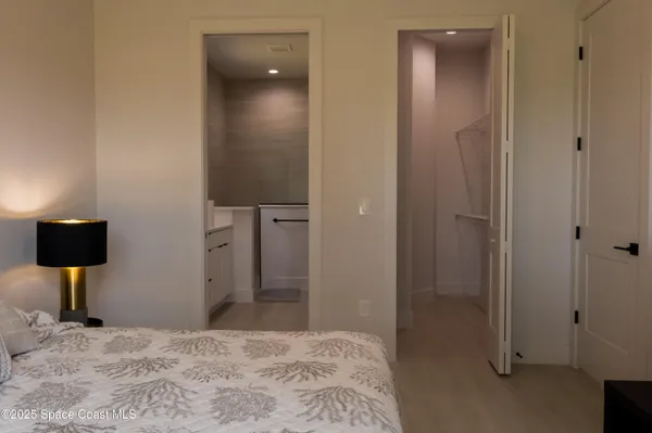 a bedroom with a bed and a mirror