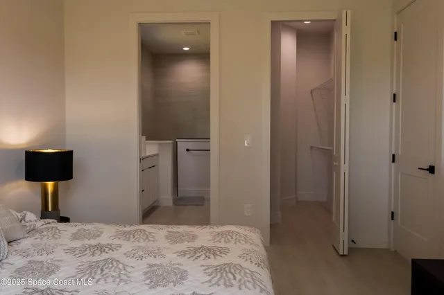 a bedroom with a bed and a mirror
