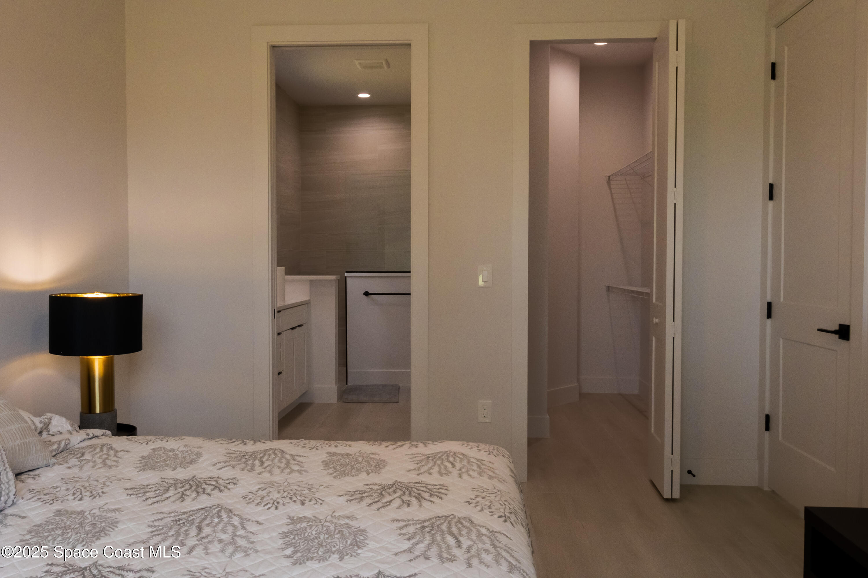 2148 Country Club Road Melbourne, FL 32901 - Photo 17 of 30 a bedroom with a bed and a mirror