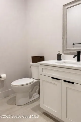 a bathroom with a sink toilet and mirror
