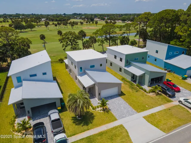 an aerial view of a house with a big yard