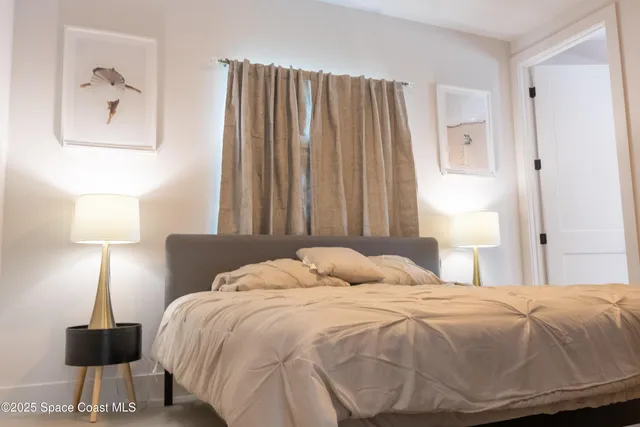 a bedroom with a bed and a lamp