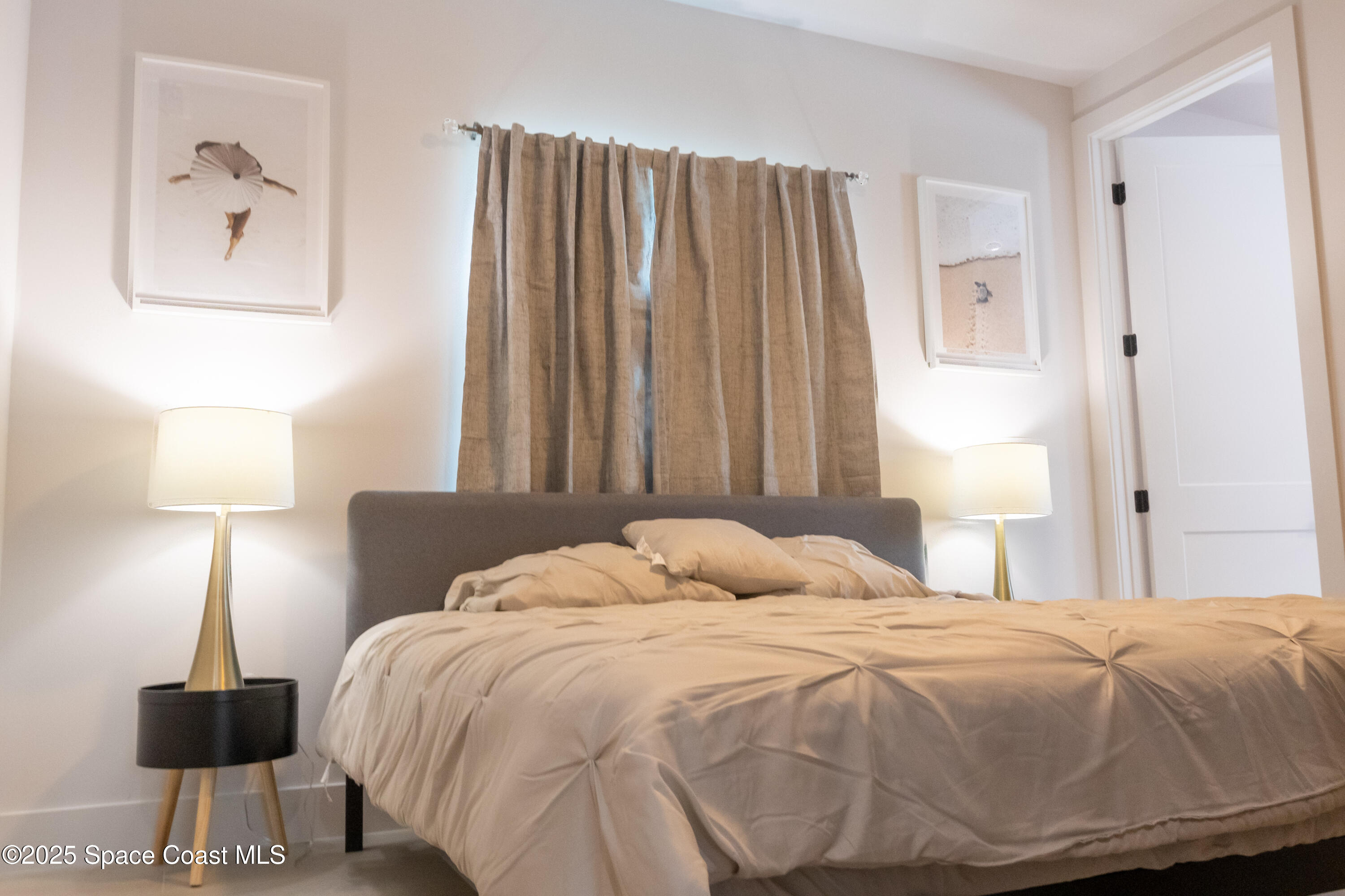 2148 Country Club Road Melbourne, FL 32901 - Photo 22 of 30 a bedroom with a bed and a lamp