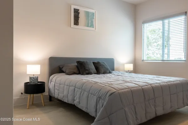 a bedroom with a bed and a lamp