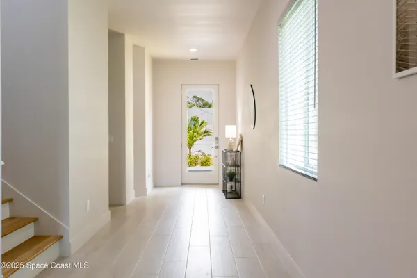 a view of an entryway with wooden floor