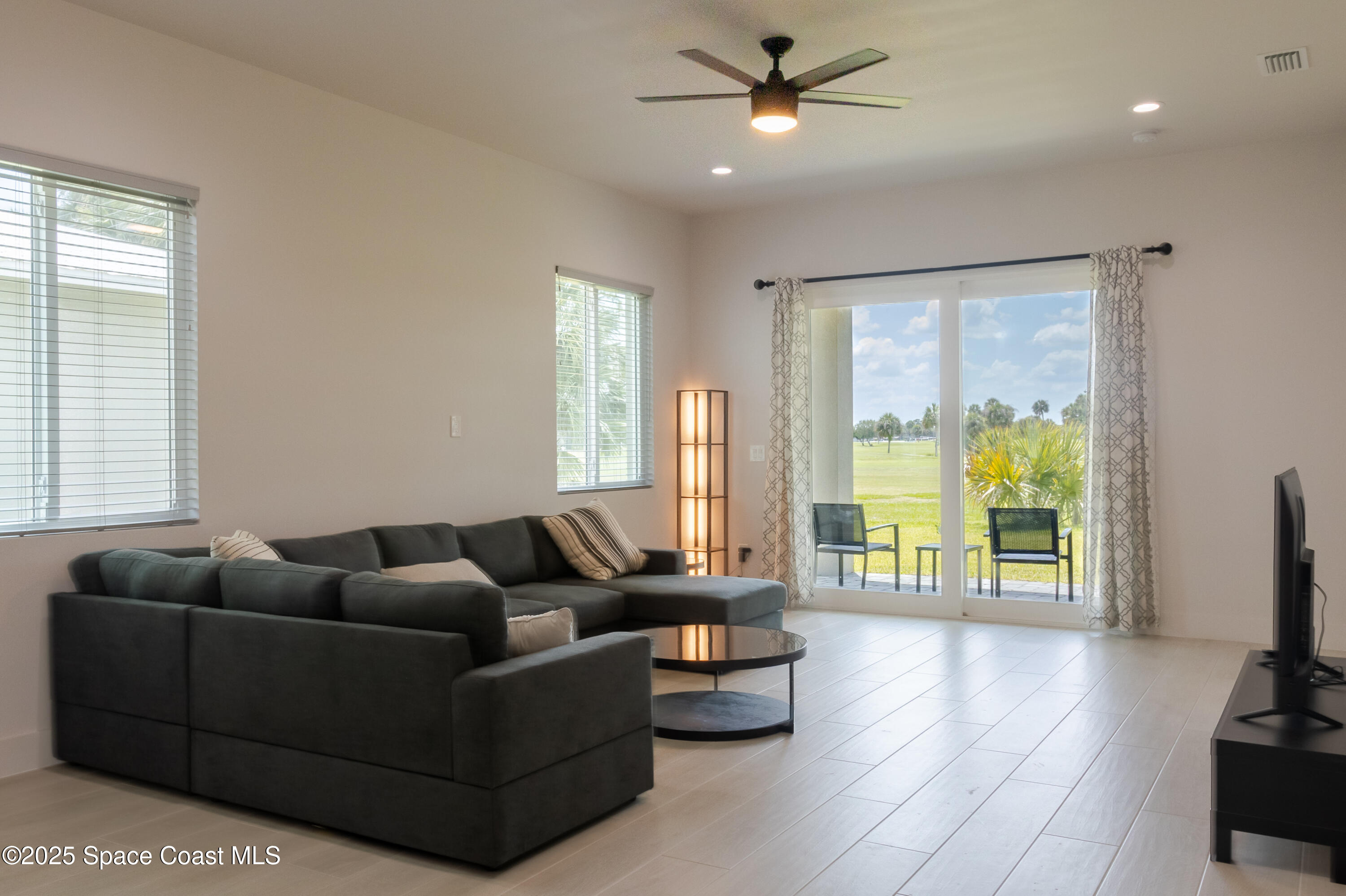 2148 Country Club Road Melbourne, FL 32901 - Photo 9 of 30 a living room with furniture and a flat screen tv