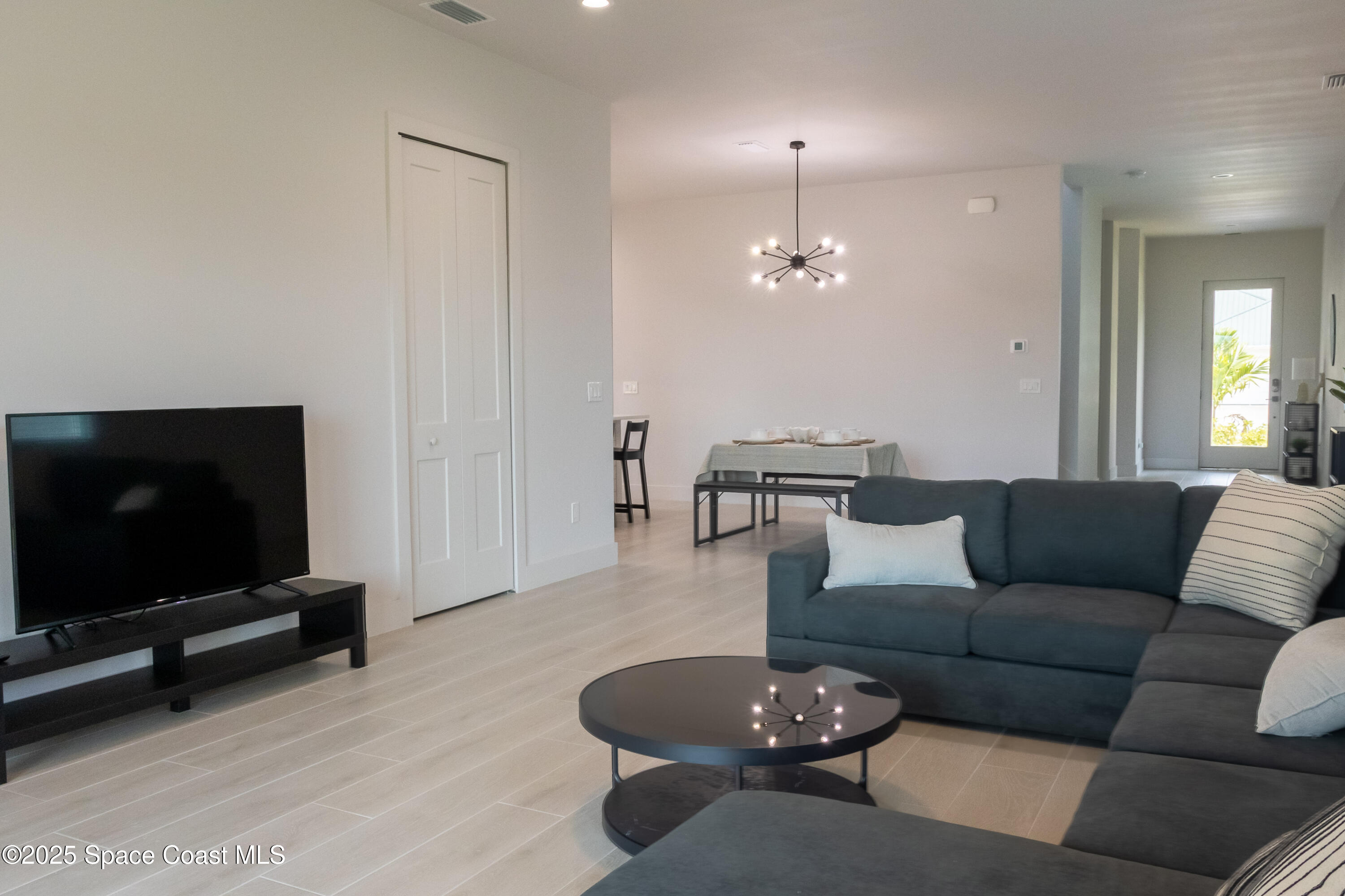 2148 Country Club Road Melbourne, FL 32901 - Photo 10 of 30 a living room with furniture and a flat screen tv