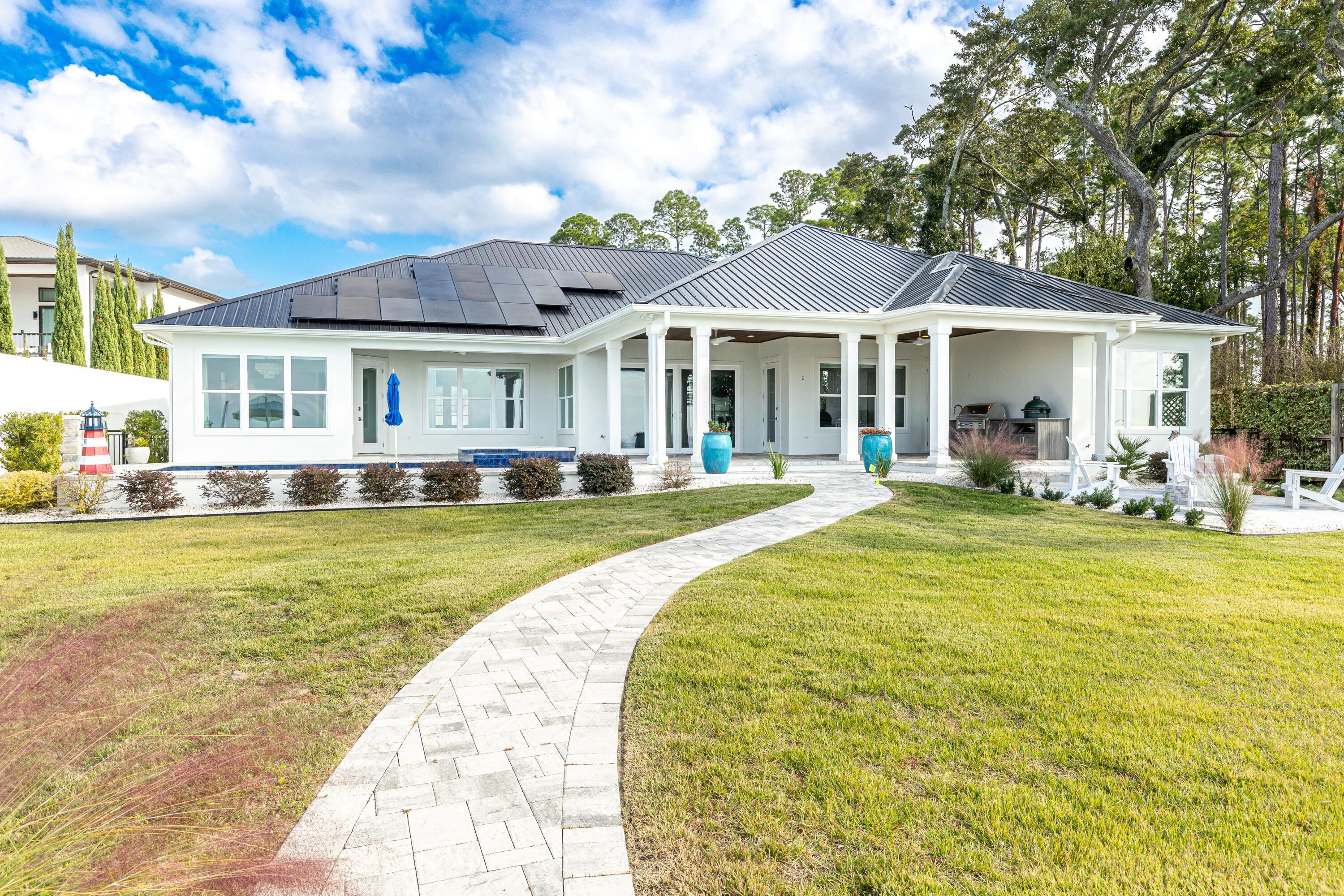 399 Driftwood Point Road Santa Rosa Beach, FL 32459 - Photo 71 of 94 a front view of a house with swimming pool and furniture