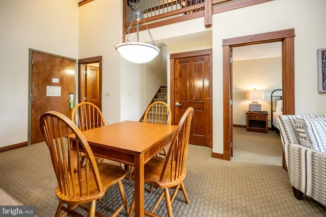 a dining room with furniture and a chandelier