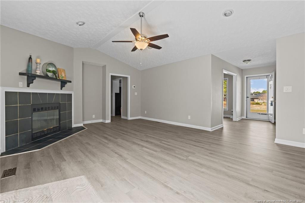 124 East Lake Ridge Road Raeford, NC 28376 - Photo 12 of 44 a view of a livingroom with wooden floor and a ceiling fan