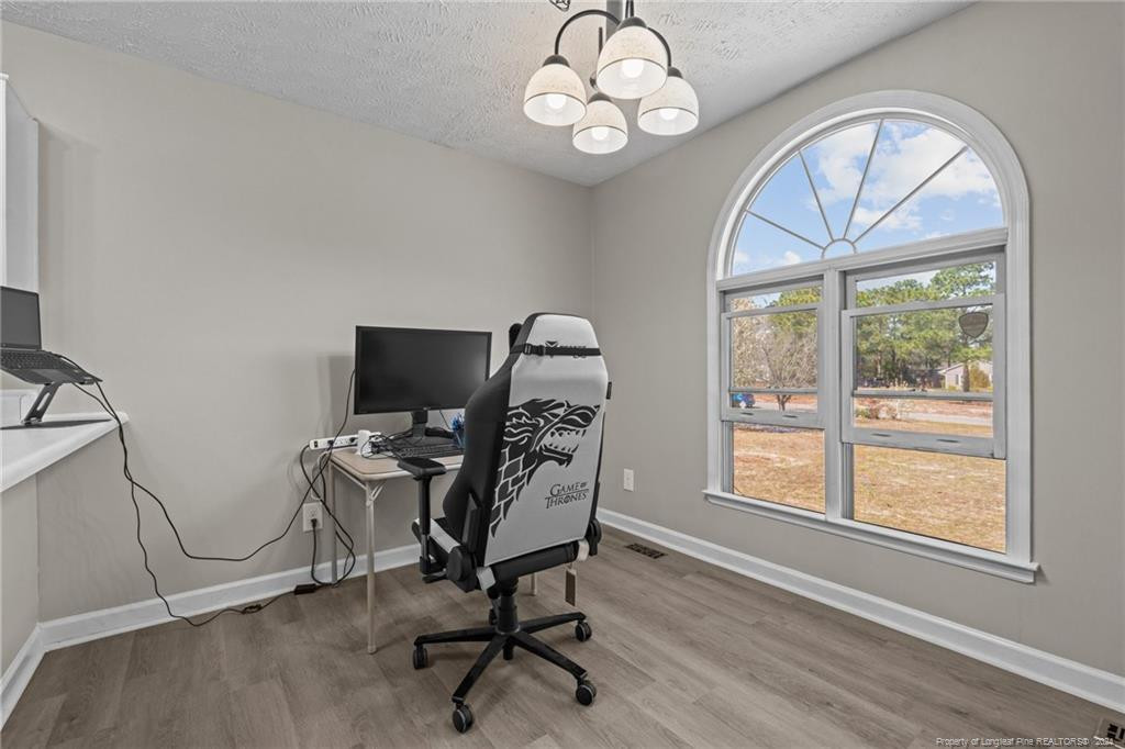 124 East Lake Ridge Road Raeford, NC 28376 - Photo 20 of 44 a view of a workspace with furniture and a window