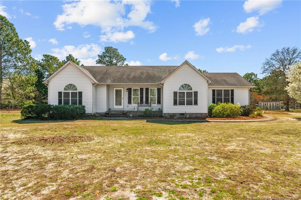 124 East Lake Ridge Road Raeford, NC 28376 - Photo 2 of 44 a front view of a house with a yard