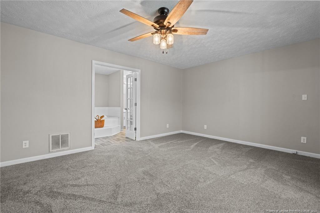 124 East Lake Ridge Road Raeford, NC 28376 - Photo 23 of 44 an empty room with fan and windows