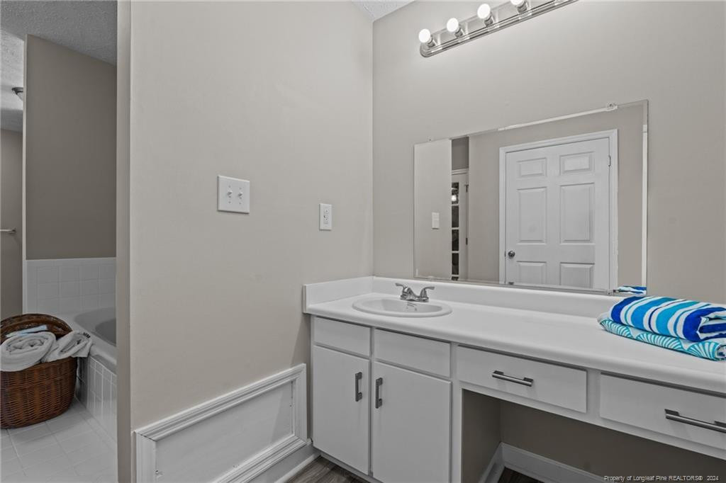 124 East Lake Ridge Road Raeford, NC 28376 - Photo 24 of 44 a bathroom with a sink and a mirror