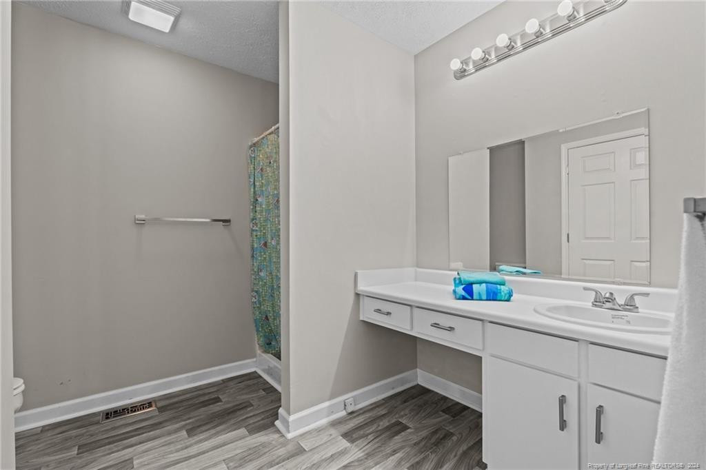 124 East Lake Ridge Road Raeford, NC 28376 - Photo 25 of 44 a bathroom with a sink and a mirror