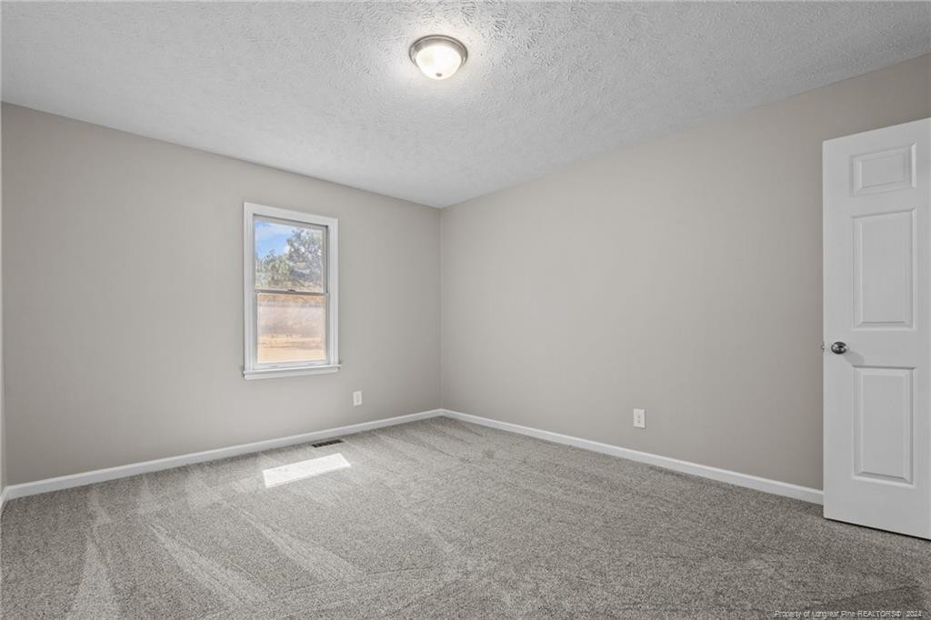 124 East Lake Ridge Road Raeford, NC 28376 - Photo 27 of 44 an empty room with a window