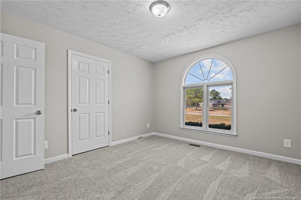124 East Lake Ridge Road Raeford, NC 28376 - Photo 29 of 44 an empty room with windows and mirror