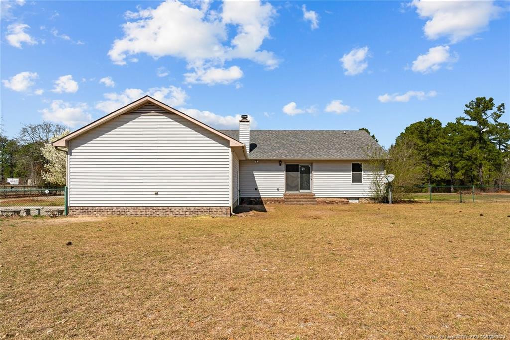 124 East Lake Ridge Road Raeford, NC 28376 - Photo 34 of 44 a view of a house with a yard