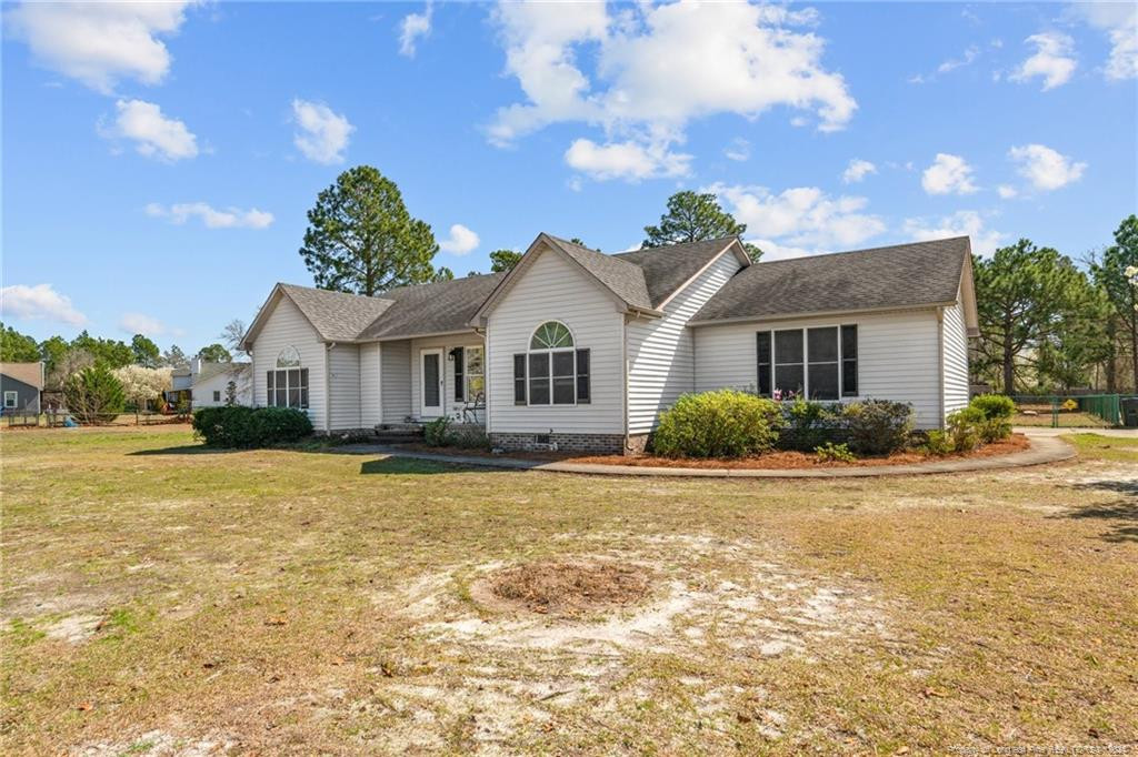 124 East Lake Ridge Road Raeford, NC 28376 - Photo 4 of 44 a front view of a house with a yard