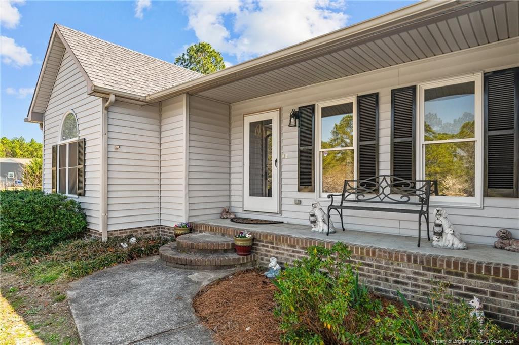 124 East Lake Ridge Road Raeford, NC 28376 - Photo 5 of 44 a front view of house with outdoor seating