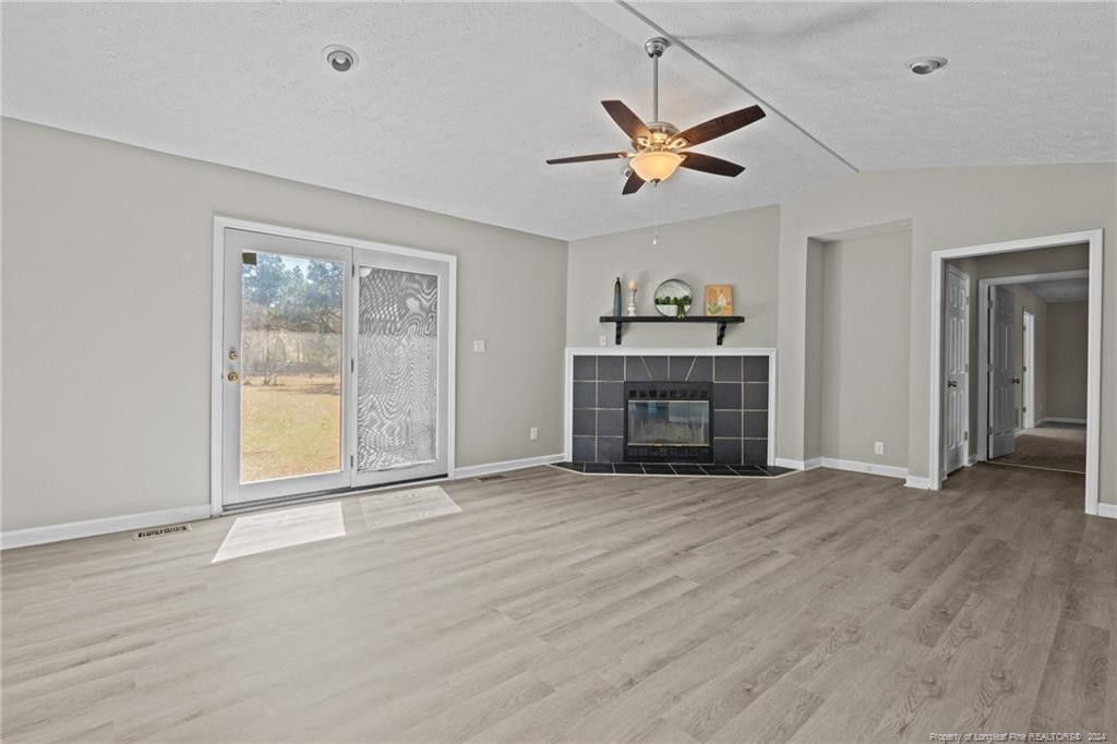 124 East Lake Ridge Road Raeford, NC 28376 - Photo 10 of 44 an empty room with ceiling fan and windows