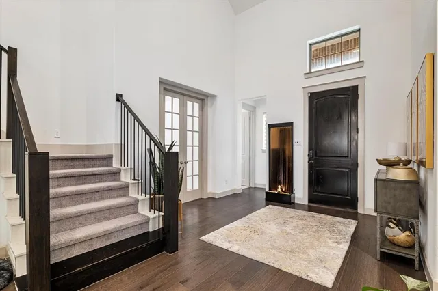 a view of a livingroom with wooden floor and stairs