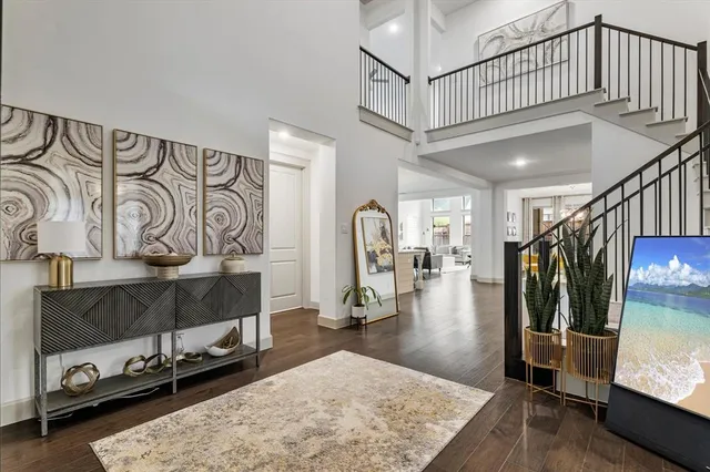 a view of a livingroom with wooden floor and stairs