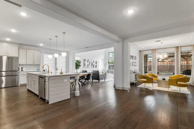 a kitchen with kitchen island a stove a sink a center island and cabinets