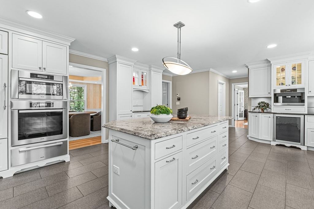 20 Algonquian Drive Natick, MA 01760 - Photo 13 of 40 a kitchen with stainless steel appliances kitchen island granite countertop a stove a sink and a refrigerator